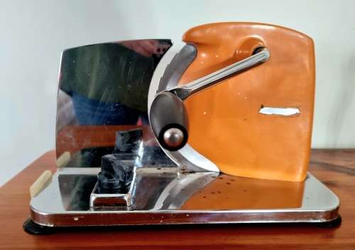 Orange enamel and steel retro bread slicer