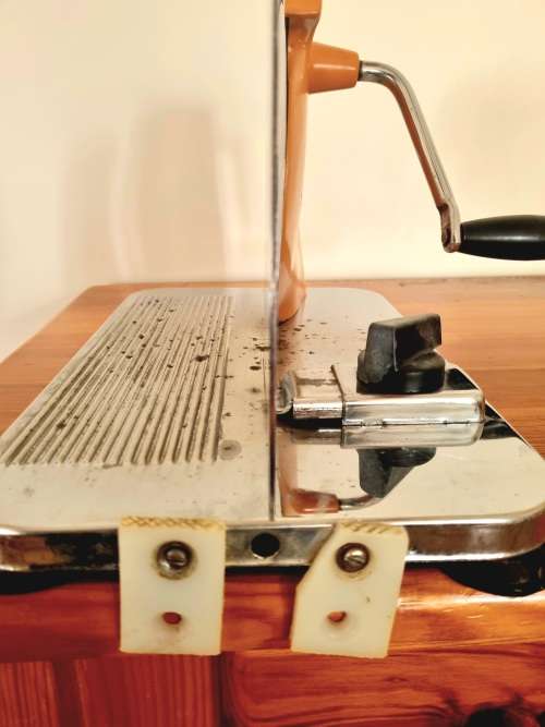 Orange enamel and steel retro bread slicer