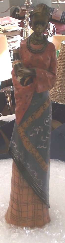 CERAMIC AND METAL FIGURINE OF A TALL LADY