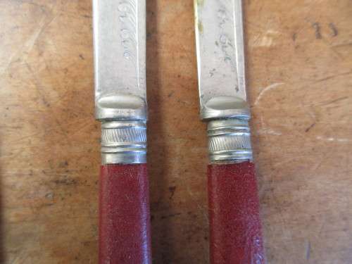 6 Red resin handled butter knives