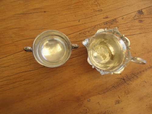 A TWIN HANDLED BOWL ( WALKER AND HALL) AND A CREAMER JUG SILVER PLATED