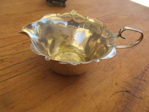 A TWIN HANDLED BOWL ( WALKER AND HALL) AND A CREAMER JUG SILVER PLATED