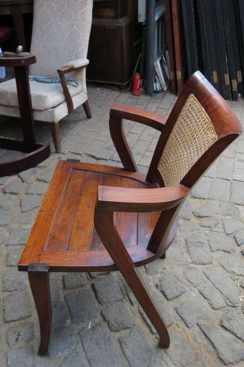 A LOVELY TEAK ARMCHAIR WITH RATTAN BACK