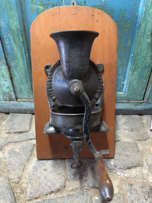 ORIGINAL SPONG COFFEE GRINDER WITH ORIGINAL BOWL MOUNTED ON YELLOW WOOD BACKING