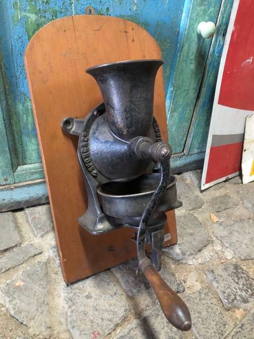 ORIGINAL SPONG COFFEE GRINDER WITH ORIGINAL BOWL MOUNTED ON YELLOW WOOD BACKING