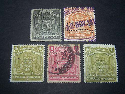 BSAC 5 x  ARMS Overprinted Rhodesia  (hinged) incl 5/- fiscally used