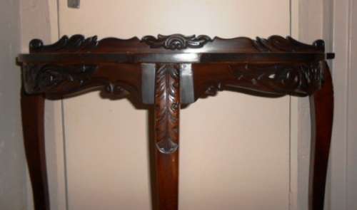 Ornately carved occasional half-moon table with Louis XV  legs and glass top