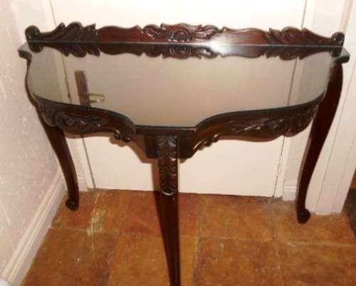 Ornately carved occasional half-moon table with Louis XV  legs and glass top