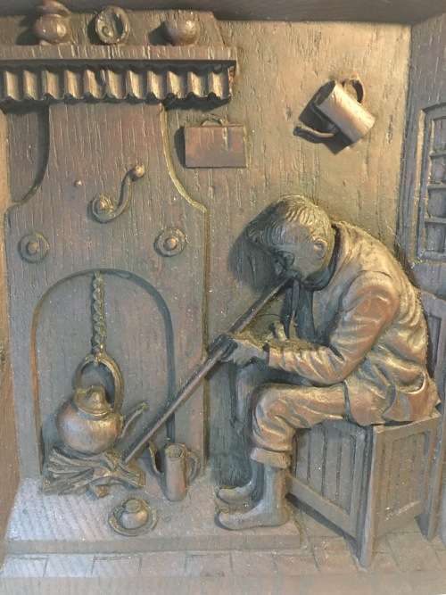 A HEAVY CARVED ANTIQUE BLACK FOREST FOLK WALL PLAQUE