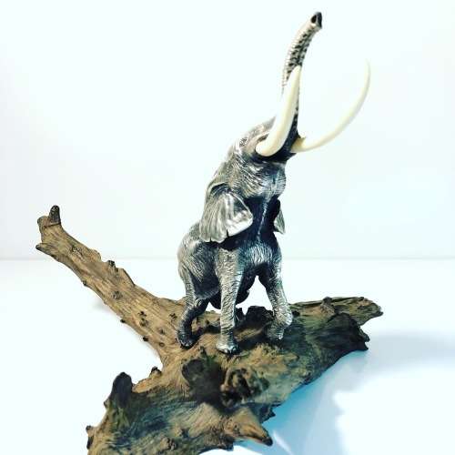 A PATRICK MAVROS SOLID HALLMARKED SILVER ELEPHANT ON WOODEN BASE