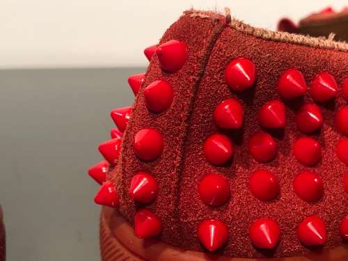 A Pair of Second Hand Christian Louboutin Red Spike Boat Shoes size 8.5