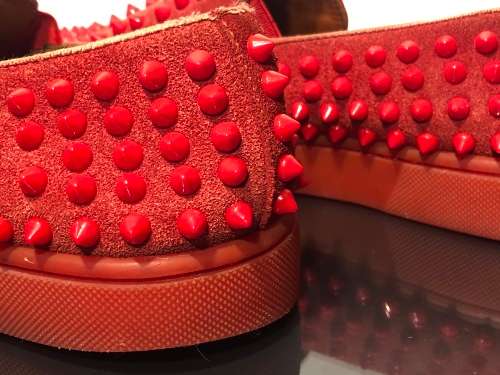 A Pair of Second Hand Christian Louboutin Red Spike Boat Shoes size 8.5