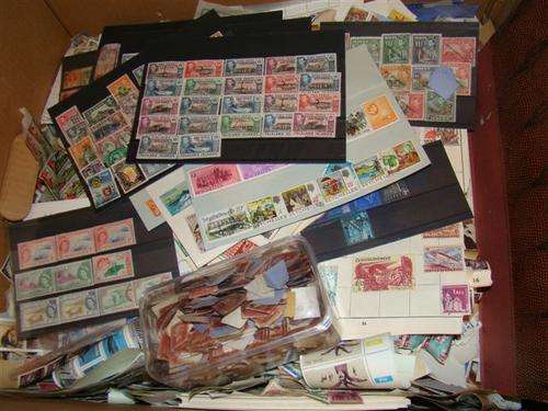A box full of loose stamps plus two albums with some stamps in shipping will be R60
