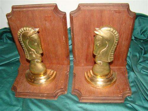 A pair of brass Knights BOOKENDS, on wooden L-shaped brackets, 22cm high