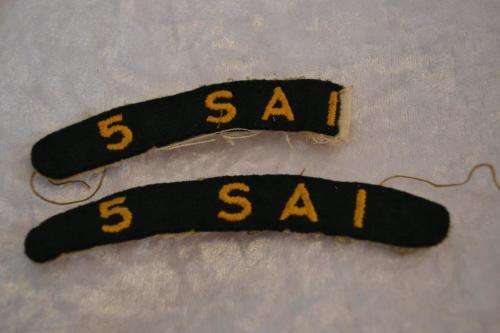 5 SAI cloth shoulder titles. One damaged.