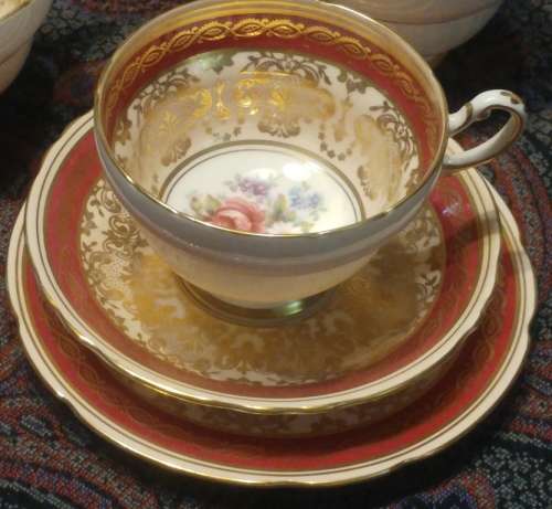 Elegant Royal Paragon floral sprig gold, pink and a maroon band Rococo-style Tea trio 1952-1956