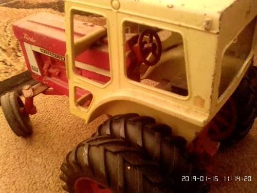 International tractor with plough, wagon and two cars