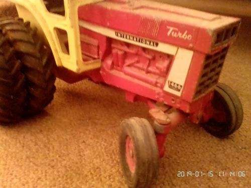 International tractor with plough, wagon and two cars