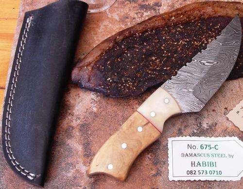 Damascus steel Biltong Knife. Brass/Bone/Wood, leather sheath. Was R 1950.00. NOW ONLY R899.00