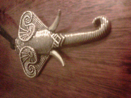 Alloy elephant on black leather