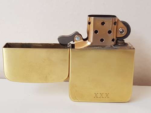 Excellent new condition. Zippo XXX lighter. Solid brass. Working.  Gold colour.