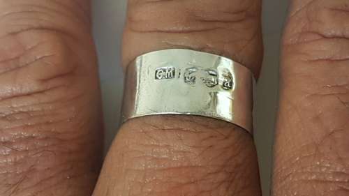 Solid sterling silver hallmarked ring.  Made from vintage bottle lid.