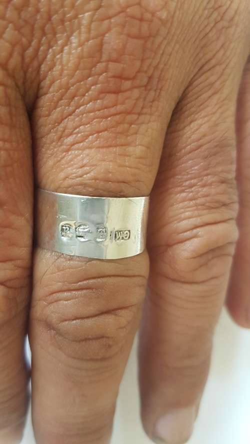 Solid sterling silver hallmarked ring.  Made from vintage bottle lid.