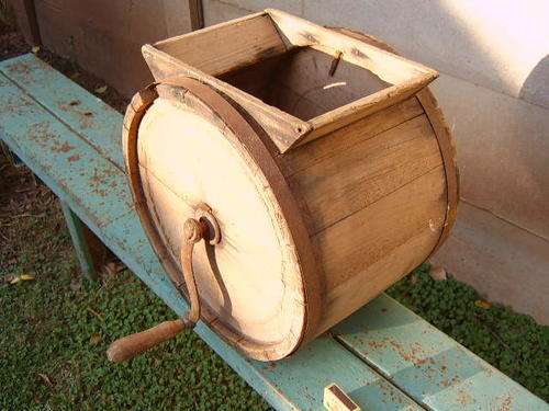 Butter churn made from wood and steel with handle.