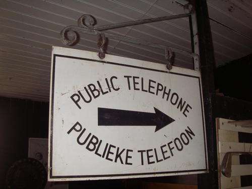 Antique enamel Public telephone sign with blacksmith hanger