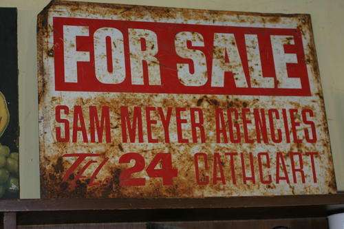 Check the low phone number on this sign very old