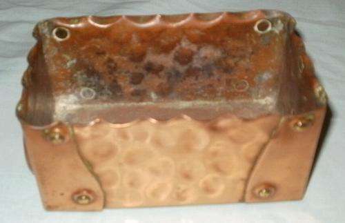 A SMALL COPPER PLANT HOLDER