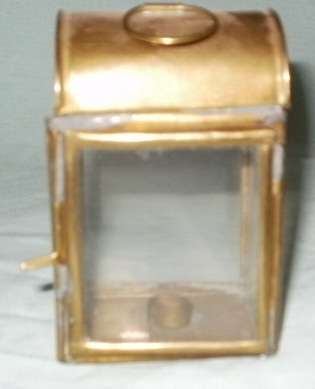 A BRASS AND GLASS MINITURE CANDLE HOLDER