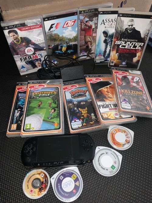 Sony Psp E1004 console with 14 Games. most sealed.