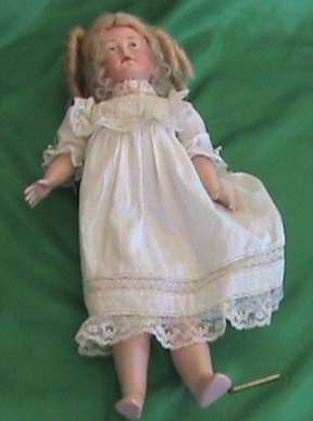 Antique Reproduction porcelain doll head on composition body. From private collection.