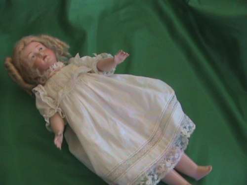Antique Reproduction porcelain doll head on composition body. From private collection.