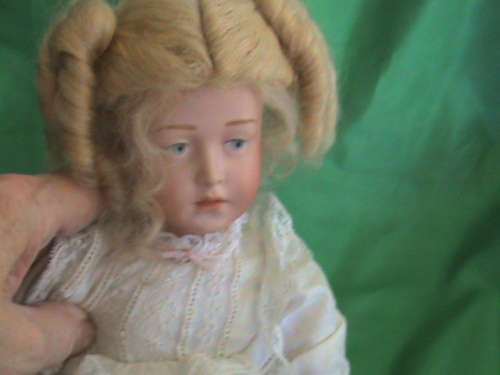 Antique Reproduction porcelain doll head on composition body. From private collection.