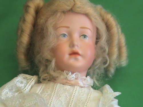 Antique Reproduction porcelain doll head on composition body. From private collection.