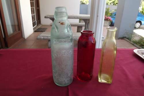 Lot of 3 bottles -yellow ,red and old Mark Morris Oudtshoorn Soda bottle with marble.Bad crack
