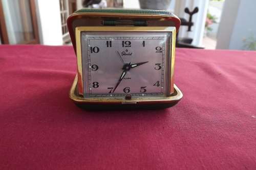 Vintage travel alarm clock.Made in Japan.In green casing.Wind -up.Over -wound.