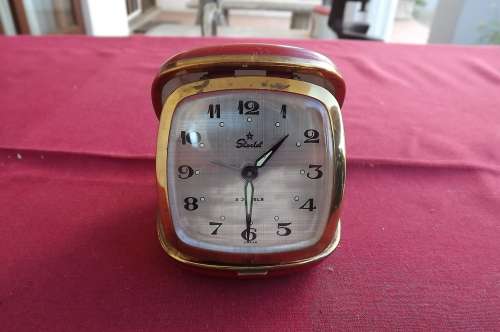 Starlet vintage travel wind - up alarm clock..Made in Japan.In red casing..Over -wound.