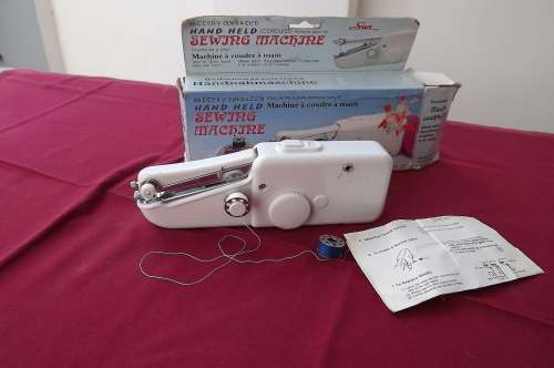 Hand held battery operated sewing machine in good condition.Complete in box