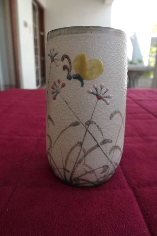 Lovely flower vase in glazed studio pottery with handpainted flower design.Height 10cm