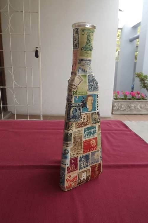 Bottle with 3 sides Decoupaged with old stamps.Good condition.Height 24cm