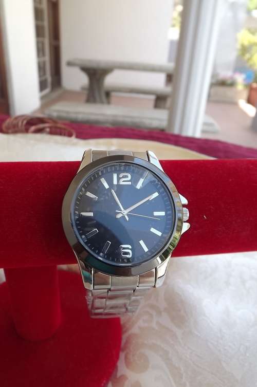 Men's watch with black face and stainless steel strap.New watch from the East.