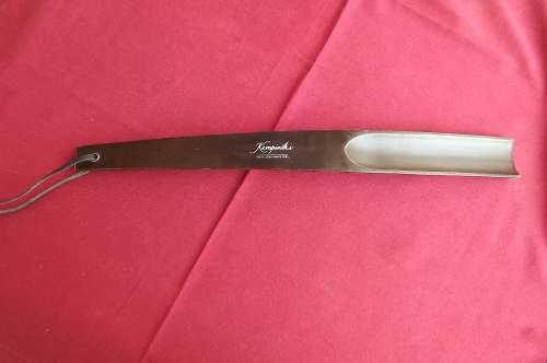 Shoe horn by KEMPINSKI HOTELLIERS. 38cm long.