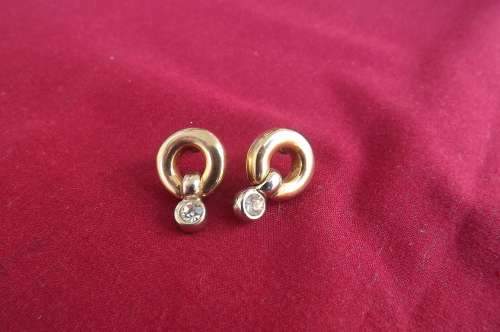 Beautiful small gold toned circle piercing earrings with loose piece hanging at bottom with stone