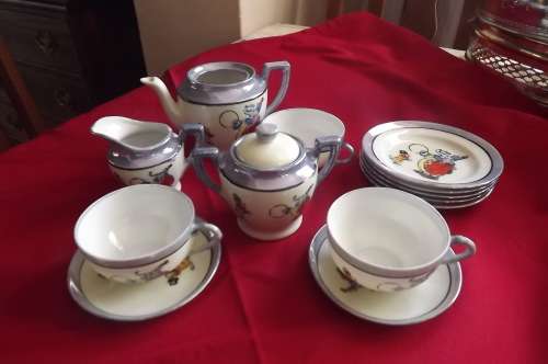 Set of 14 piece small porcelain tea set with circus animal design.