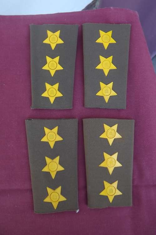 Two sets of rubberized captain field dress rank.