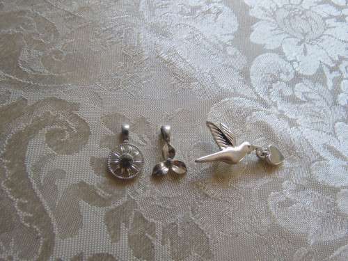 Set of 3 silver toned pretty pendants to wear with your silver chain.Still new