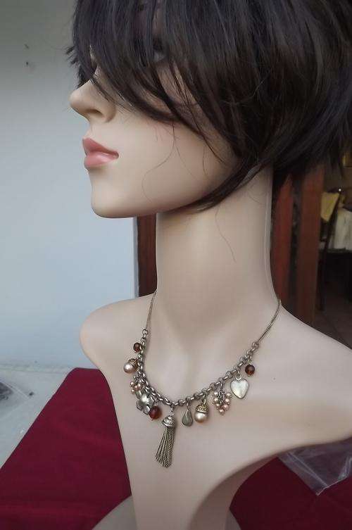 Gold colour choker type necklace with different charms.Good condition